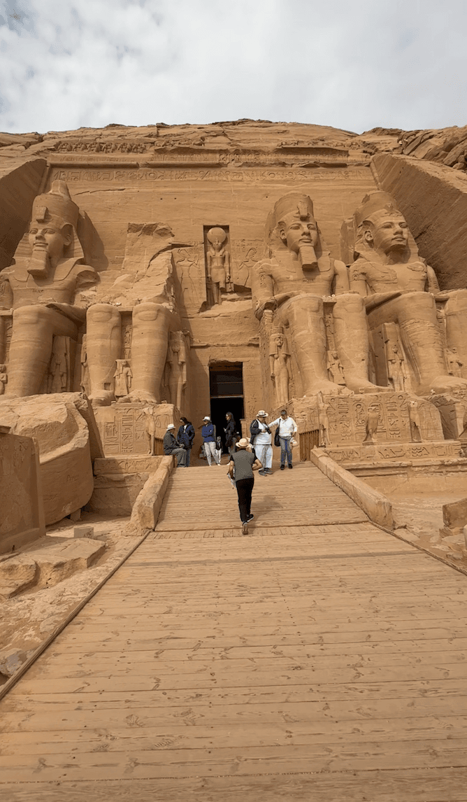 Visitors walking up to massive Abu Simbel temple facade during private Egypt tour
