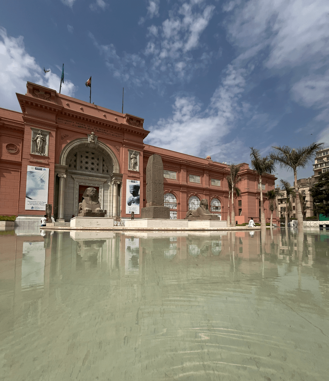 Egyptian Museum in Tahrir Square Cairo historic pink building with reflecting pool facade