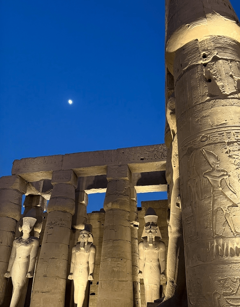 Luxor Temple at night with moon reflecting ancient astronomical observations